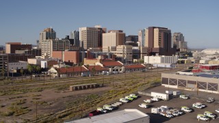 DX0002_142_018 - 5.7K aerial stock footage approach and flyby train station with view of skyline in Downtown Phoenix, Arizona