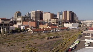 DX0002_142_020 - 5.7K aerial stock footage of flying away from the city's skyline and train station in Downtown Phoenix, Arizona