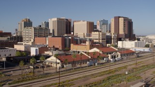 DX0002_142_022 - 5.7K aerial stock footage of the city's skyline seen while flying past and away from train station in Downtown Phoenix, Arizona