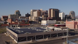 DX0002_142_023 - 5.7K aerial stock footage of the city's skyline seen while flying past train station in Downtown Phoenix, Arizona