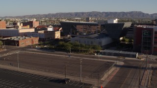 DX0002_142_032 - 5.7K aerial stock footage fly away from the Maricopa County Sheriff’s Office at sunset in Downtown Phoenix, Arizona