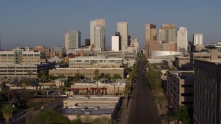 DX0002_143_002 - 5.7K aerial stock footage flyby and away from high-rise office buildings of the city's skyline and Adams Street at sunset in Downtown Phoenix, Arizona