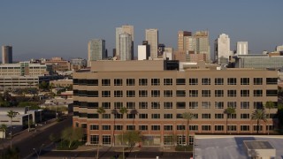 DX0002_143_003 - 5.7K aerial stock footage the city's skyline while flying by state government offices at sunset in Downtown Phoenix, Arizona