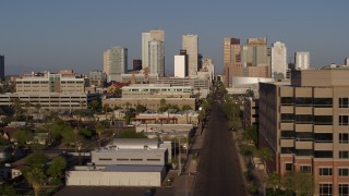 DX0002_143_004 - 5.7K aerial stock footage flying by state government offices to reveal Adams Street to skyline at sunset in Downtown Phoenix, Arizona