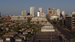 DX0002_143_005 - 5.7K aerial stock footage flying by Adams Street leading to the city's skyline at sunset in Downtown Phoenix, Arizona