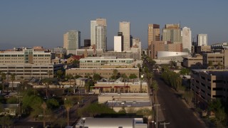 DX0002_143_009 - 5.7K aerial stock footage flying near Adams Street to approach city's skyline at sunset in Downtown Phoenix, Arizona