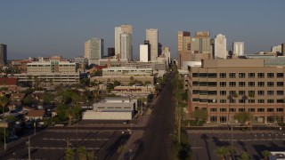 DX0002_143_011 - 5.7K aerial stock footage flyby state offices and Adams Street for view of city's skyline at sunset in Downtown Phoenix, Arizona