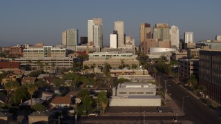 DX0002_143_012 - 5.7K aerial stock footage follow Adams Street toward city's skyline at sunset in Downtown Phoenix, Arizona