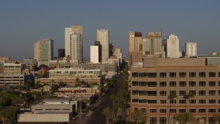 DX0002_143_014 - 5.7K aerial stock footage flyby Adams Street and state office building, focus on city's skyline at sunset, Downtown Phoenix, Arizona