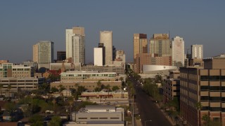 DX0002_143_015 - 5.7K aerial stock footage flyby state office building to reveal Adams Street, focus on city's skyline at sunset, Downtown Phoenix, Arizona