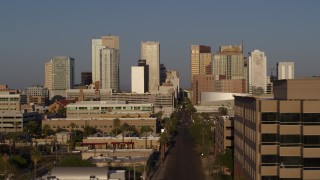 DX0002_143_016 - 5.7K aerial stock footage focus on city's skyline at sunset and flyby Adams Street, Downtown Phoenix, Arizona