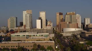 DX0002_143_018 - 5.7K aerial stock footage focus on city's skyline at sunset, flyby Adams Street, Downtown Phoenix, Arizona