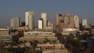 DX0002_143_021 - 5.7K aerial stock footage focus on city's skyline at sunset, fly back and forth across Adams Street, Downtown Phoenix, Arizona