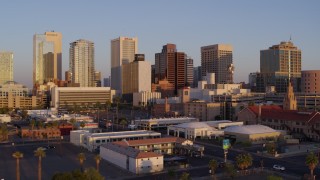 DX0002_143_031 - 5.7K aerial stock footage of a reverse view of the city's skyline at sunset, Downtown Phoenix, Arizona