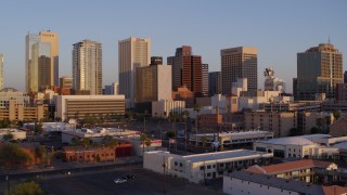 DX0002_143_032 - 5.7K stock footage aerial video of flying toward the city's skyline at sunset, Downtown Phoenix, Arizona