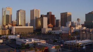 DX0002_143_033 - 5.7K stock footage aerial video of flying past the city's skyline at sunset, Downtown Phoenix, Arizona