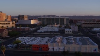 DX0002_143_038 - 5.7K aerial stock footage of a performing arts theater, federal courthouse and TV station at sunset, Downtown Phoenix, Arizona