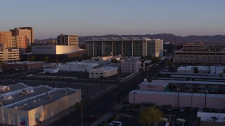 DX0002_143_039 - 5.7K aerial stock footage of a view of a performing arts theater, courthouse and TV station at sunset, Downtown Phoenix, Arizona