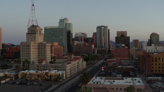 DX0002_143_045 - 5.7K aerial stock footage of tall office towers and city streets at sunset, Downtown Phoenix, Arizona