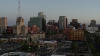 DX0002_143_047 - 5.7K aerial stock footage of a view of the Westward Ho building and tall office towers at sunset, Downtown Phoenix, Arizona
