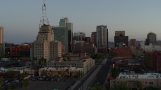 DX0002_143_049 - 5.7K aerial stock footage of towering office buildings seen from 1st Avenue at sunset, Downtown Phoenix, Arizona