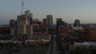 DX0002_143_050 - 5.7K stock footage aerial video of passing towering office buildings seen from 1st Avenue at sunset, Downtown Phoenix, Arizona