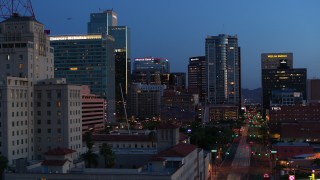 DX0002_143_056 - 5.7K stock footage aerial video of towering office buildings, reveal Westward Ho building at twilight, Downtown Phoenix, Arizona