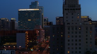 DX0002_143_060 - 5.7K aerial stock footage passing high-rise office buildings, and reveal Westward Ho building at twilight, Downtown Phoenix, Arizona