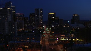 DX0002_143_072 - 5.7K aerial stock footage slowly passing by 1st Avenue and high-rise office towers at twilight, Downtown Phoenix, Arizona