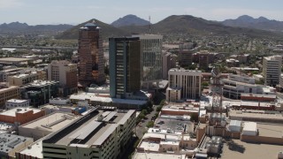 DX0002_144_003 - 5.7K aerial stock footage of orbiting high-rise office buildings, view of Sentinel Peak, Downtown Tucson, Arizona