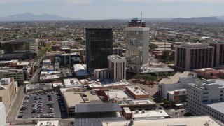 DX0002_144_004 - 5.7K aerial stock footage of a wide orbit of office high-rise buildings in Downtown Tucson, Arizona