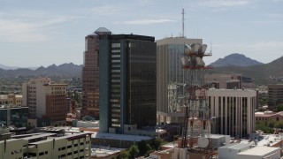 DX0002_144_017 - 5.7K aerial stock footage descend to orbit office towers in Downtown Tucson, Arizona