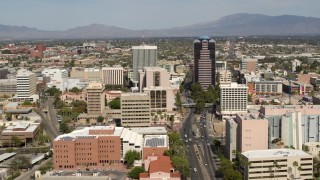 DX0002_144_027 - 5.7K aerial stock footage of flying by tall high-rise office towers and city buildings in Downtown Tucson, Arizona
