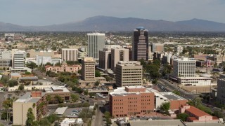 DX0002_144_033 - 5.7K aerial stock footage focus on tall high-rise office towers surrounded by city buildings in Downtown Tucson, Arizona