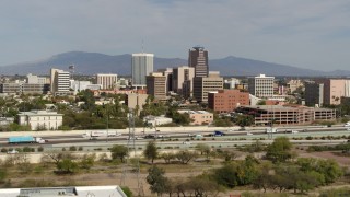 DX0002_144_040 - 5.7K aerial stock footage of tall office high-rises and city buildings, seen while approaching I-10, Downtown Tucson, Arizona