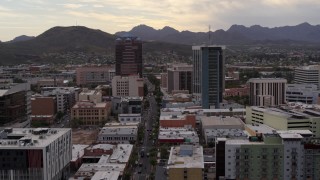 DX0002_145_034 - 5.7K aerial stock footage of a reverse view of office towers with Sentinel Peak in the background, Downtown Tucson, Arizona