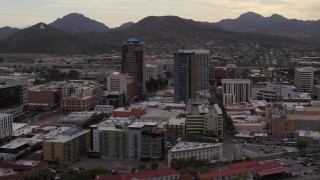 DX0002_145_041 - 5.7K aerial stock footage ascend while flying away from office towers, Sentinel Peak in distance, Downtown Tucson, Arizona