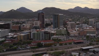 DX0002_145_042 - 5.7K aerial stock footage descend while orbiting office towers in Downtown Tucson, Arizona