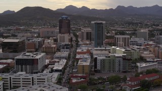 DX0002_145_044 - 5.7K aerial stock footage descend with view of Congress Street between office towers in Downtown Tucson, Arizona
