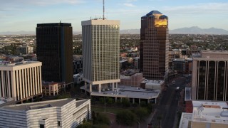 DX0002_146_021 - 5.7K aerial stock footage fly away from Bank of America Plaza office tower in Downtown Tucson, Arizona