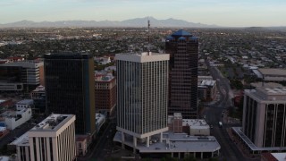 DX0002_146_024 - 5.7K aerial stock footage orbit and fly away from Bank of America Plaza office tower in Downtown Tucson, Arizona