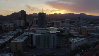 DX0002_146_039 - 5.7K aerial stock footage approach and flyby high-rise office towers and setting sun in Downtown Tucson, Arizona
