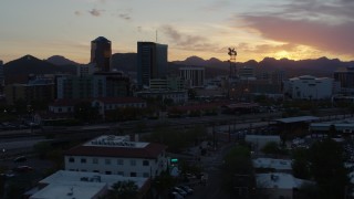 DX0002_146_045 - 5.7K aerial stock footage focusing on high-rise office towers and city buildings at sunset in Downtown Tucson, Arizona