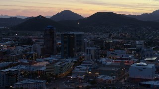 DX0002_147_018 - 5.7K aerial stock footage tall office towers at sunset, Sentinel Peak in the distance, Downtown Tucson, Arizona