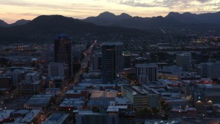 DX0002_147_020 - 5.7K aerial stock footage focus on tall office towers at sunset while flying by Downtown Tucson, Arizona