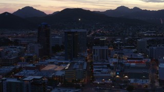 DX0002_147_023 - 5.7K aerial stock footage slowly passing tall office towers at sunset, Downtown Tucson, Arizona