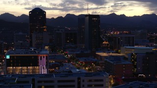 DX0002_147_028 - 5.7K aerial stock footage orbit tall office towers and Congress Street at sunset, Downtown Tucson, Arizona