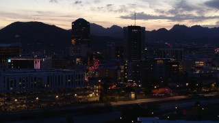 DX0002_147_030 - 5.7K aerial stock footage ascend and approach tall office towers and Congress Street at twilight, Downtown Tucson, Arizona