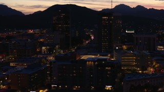 DX0002_147_036 - 5.7K aerial stock footage orbit two towering office buildings at twilight, Downtown Tucson, Arizona