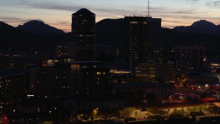 DX0002_147_037 - 5.7K aerial stock footage orbiting three towering office buildings at twilight, Downtown Tucson, Arizona